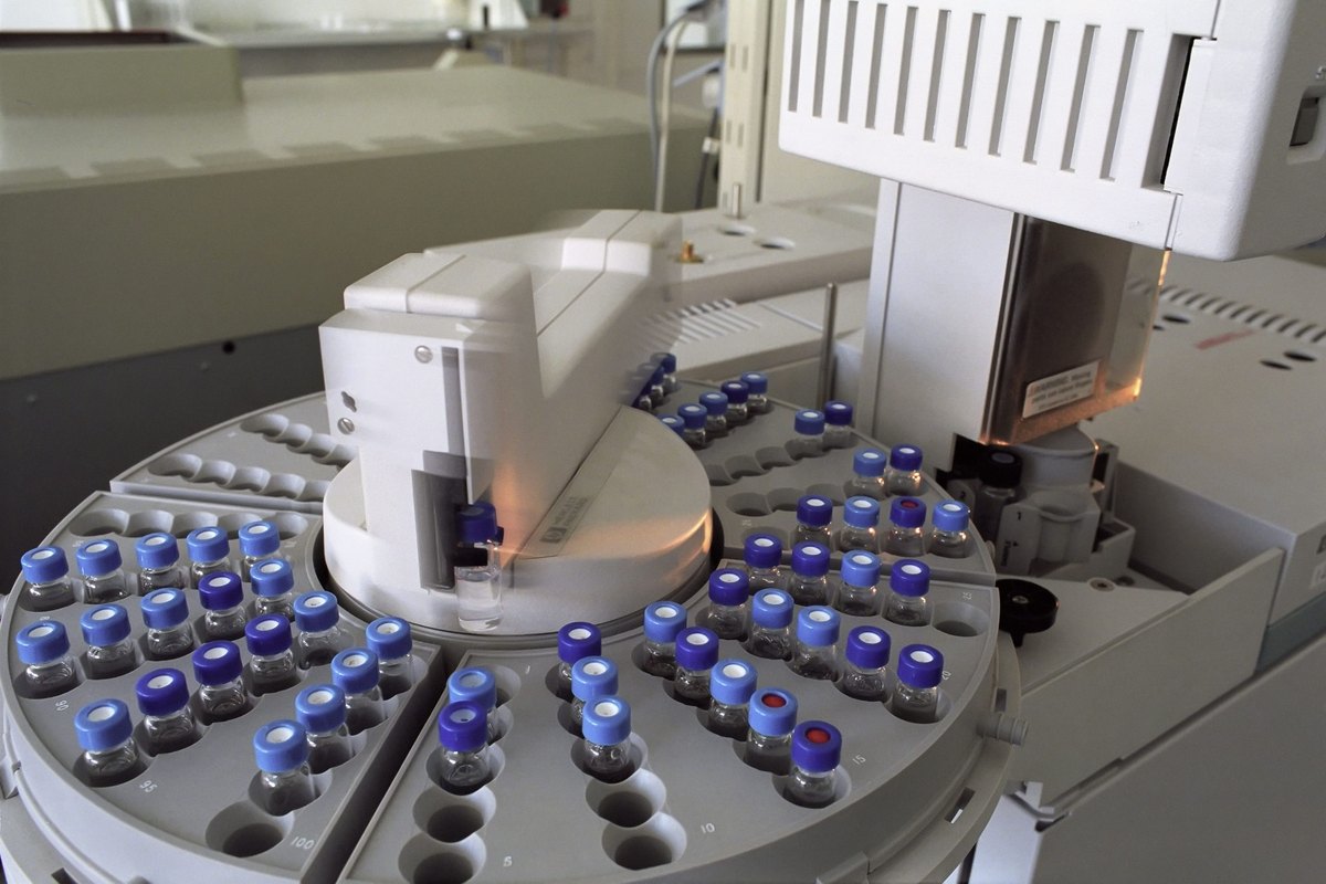 Laboratory autosampler tray of small vials with blue caps